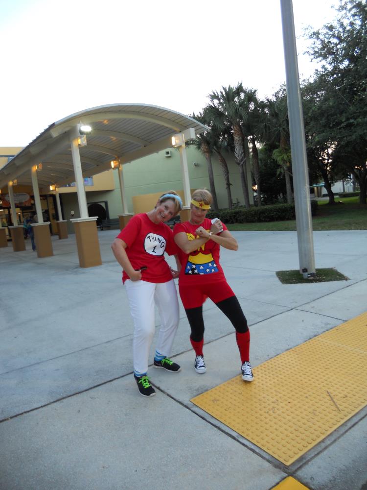 Woman dressed as Thing 1 standing next to woman dressed as Wonder Woman